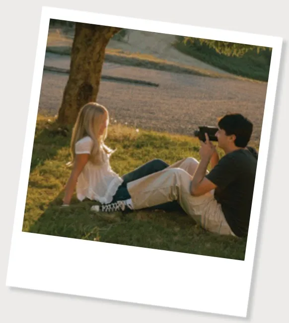 Max taking a photo of Makayla in the grass